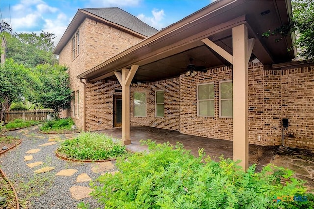 view of home's exterior featuring ceiling fan and a patio area