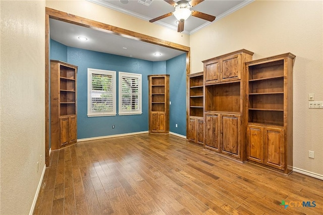 unfurnished living room featuring ceiling fan, crown molding, and hardwood / wood-style flooring