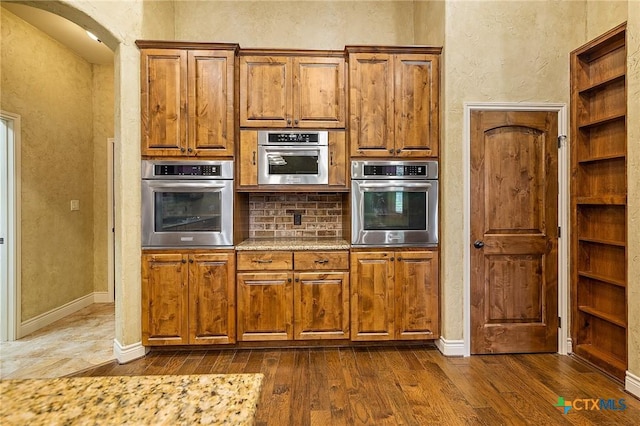 kitchen with dark wood-type flooring and oven