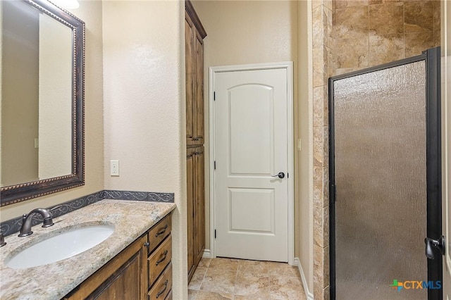 bathroom featuring walk in shower and vanity