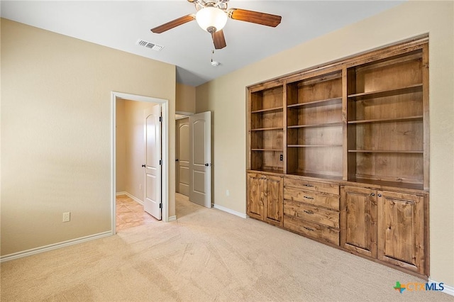 interior space featuring ceiling fan and light colored carpet