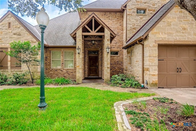 view of front facade with a garage and a front lawn