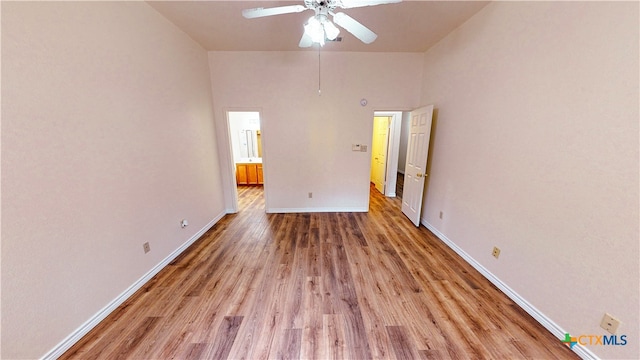 unfurnished bedroom with a high ceiling, ceiling fan, and light hardwood / wood-style flooring