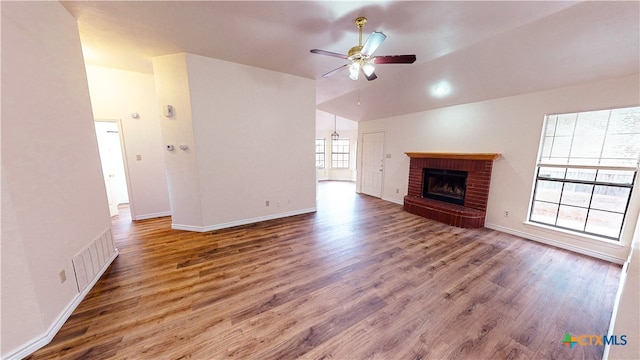 unfurnished living room with lofted ceiling, hardwood / wood-style floors, ceiling fan, and a fireplace