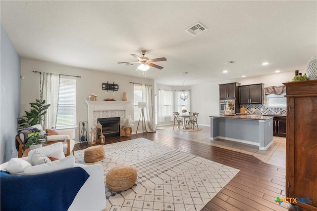 2014 Deer Field Way, Harker Heights, TX 76548 - living area with plenty of natural light, a ceiling fan, wood finish floors, a tiled fireplace, and recessed lighting