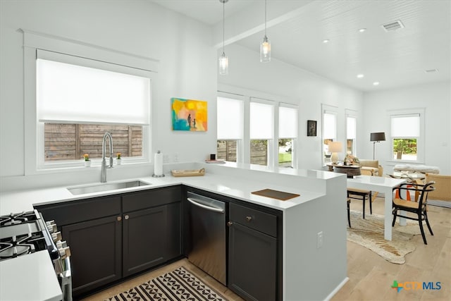 kitchen featuring white gas range oven, light wood-type flooring, decorative light fixtures, sink, and stainless steel dishwasher