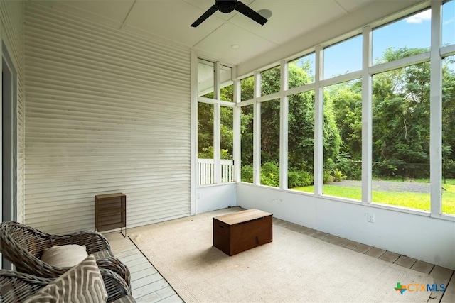 unfurnished sunroom with ceiling fan and plenty of natural light