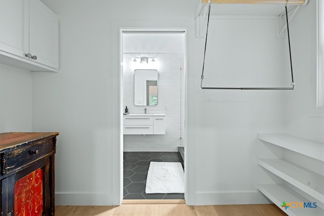 laundry area with light hardwood / wood-style floors