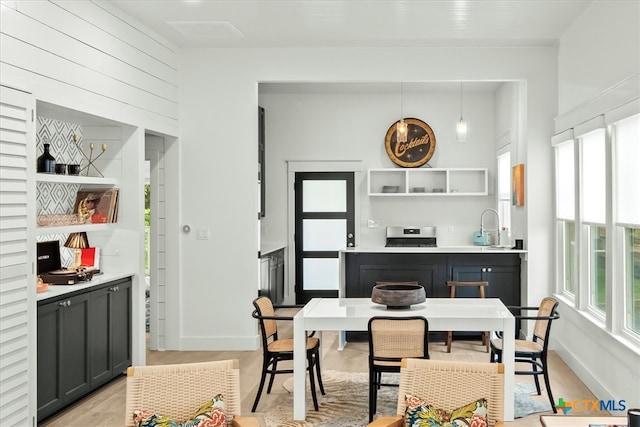 dining area featuring sink and light hardwood / wood-style flooring