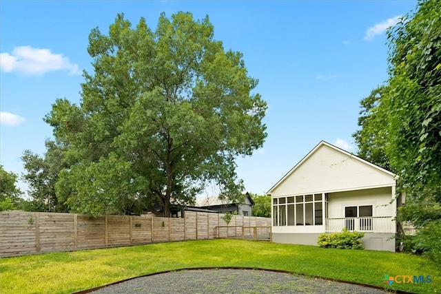 view of yard featuring a sunroom