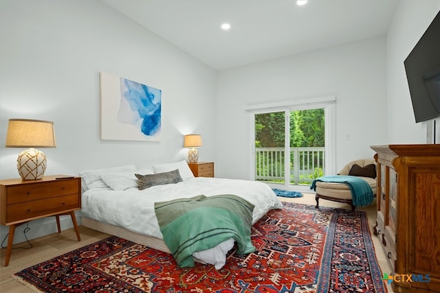 bedroom featuring access to exterior and hardwood / wood-style flooring