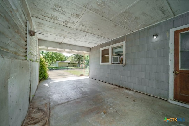 view of patio featuring cooling unit and a carport