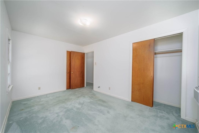 unfurnished bedroom featuring carpet flooring, a closet, and baseboards