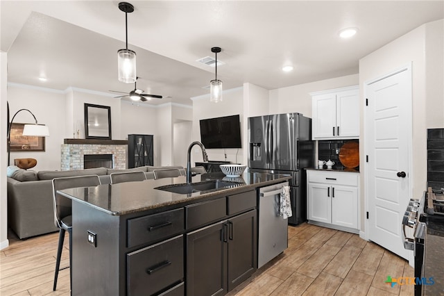 2727 Torino Reale Ave, Temple, TX 76502 - kitchen featuring ornamental molding, ceiling fan, a sink, white cabinetry, and stainless steel appliances