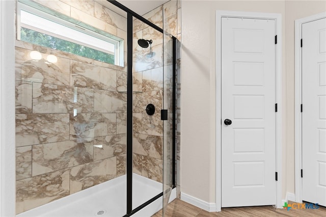2727 Torino Reale Ave, Temple, TX 76502 - full bath with baseboards, a shower stall, and wood finished floors