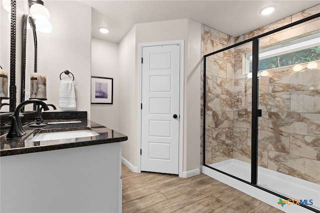 2727 Torino Reale Ave, Temple, TX 76502 - bathroom featuring a stall shower, baseboards, vanity, and wood finished floors