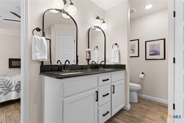 2727 Torino Reale Ave, Temple, TX 76502 - full bath with double vanity, visible vents, a sink, and wood finished floors