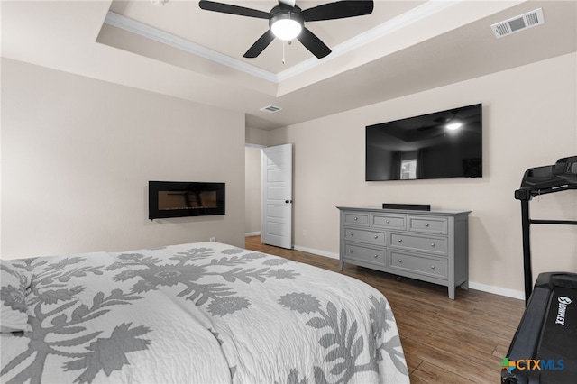 2727 Torino Reale Ave, Temple, TX 76502 - bedroom with baseboards, visible vents, crown molding, wood finished floors, and a raised ceiling