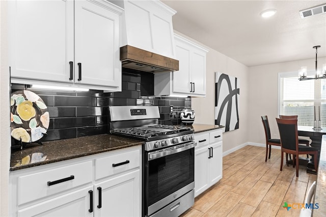 2727 Torino Reale Ave, Temple, TX 76502 - kitchen with stainless steel range with gas stovetop, decorative backsplash, baseboards, and visible vents