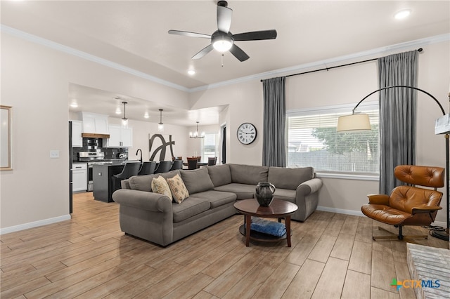2727 Torino Reale Ave, Temple, TX 76502 - living room featuring a ceiling fan, ornamental molding, and light wood-type flooring