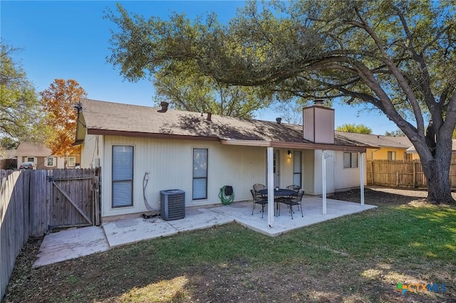 back of house featuring a yard, a patio, and central AC unit