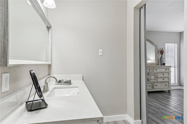 clothes washing area featuring hardwood / wood-style floors and sink