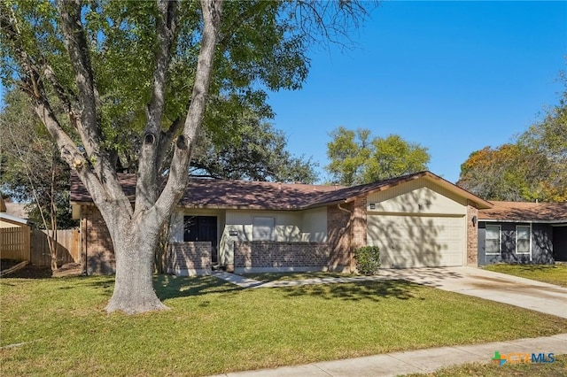 single story home with a garage and a front lawn