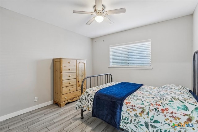 bedroom featuring light hardwood / wood-style flooring and ceiling fan