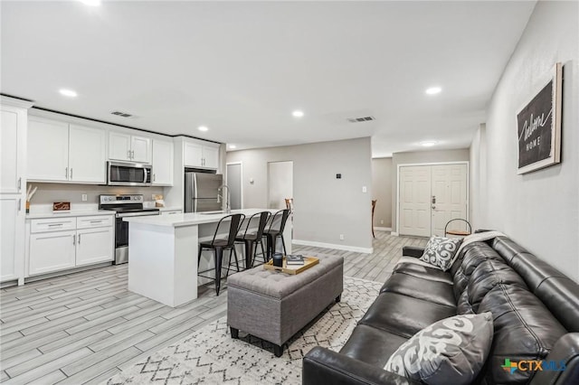 living room with a fireplace and sink