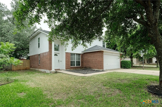 view of front of house with a garage and a front lawn