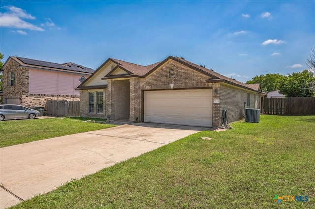 7123 Kevin Dr, Temple, TX 76502 - view of front of property with central AC unit, a garage, brick siding, and concrete driveway