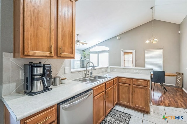 7123 Kevin Dr, Temple, TX 76502 - kitchen with stainless steel dishwasher, a sink, a peninsula, lofted ceiling, and light tile patterned floors