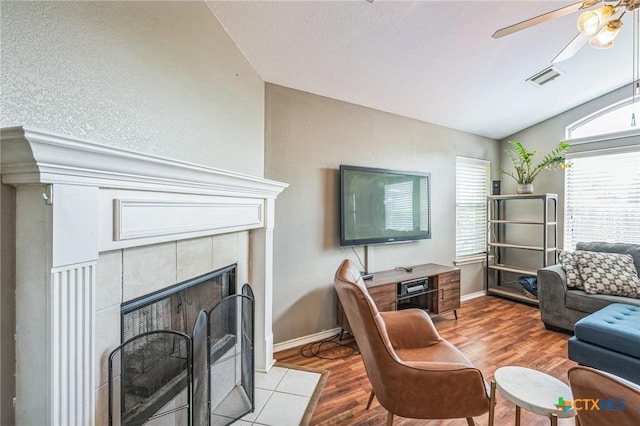 7123 Kevin Dr, Temple, TX 76502 - living room featuring lofted ceiling, wood finished floors, a fireplace, a ceiling fan, and baseboards
