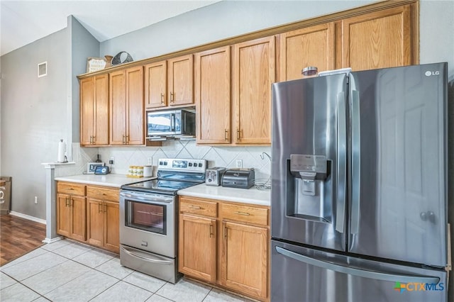 7123 Kevin Dr, Temple, TX 76502 - kitchen with stainless steel appliances, light countertops, decorative backsplash, light tile patterned floors, and baseboards