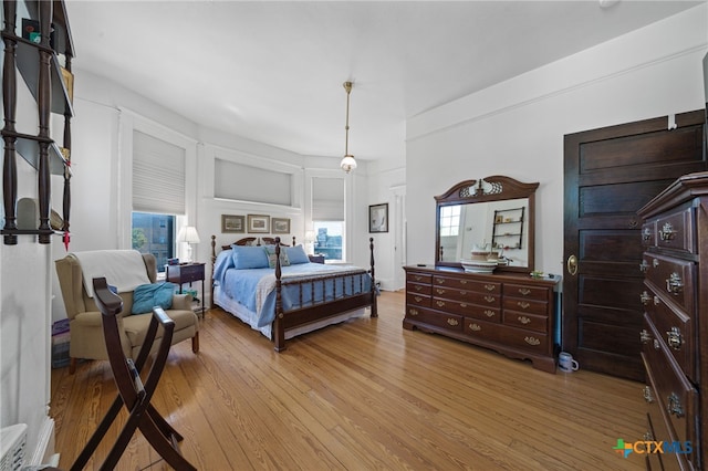 bedroom with light wood-type flooring and multiple windows