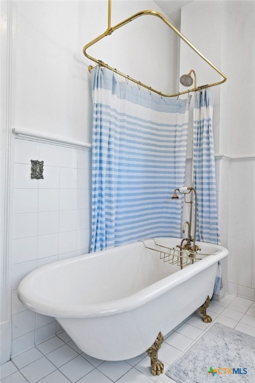 bathroom featuring shower / bath combination with curtain, tile patterned floors, and tile walls