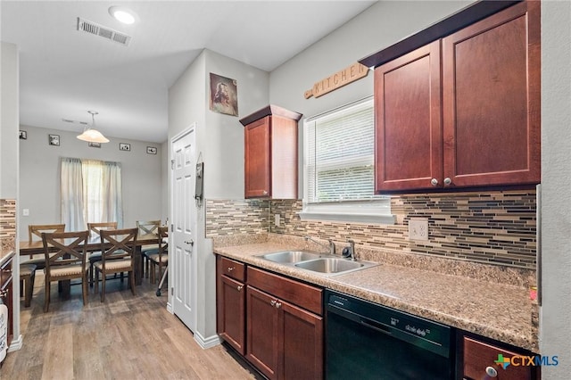 2709 Odem St, Victoria, TX 77901 - kitchen featuring dishwasher, light wood-style floors, backsplash, and light countertops