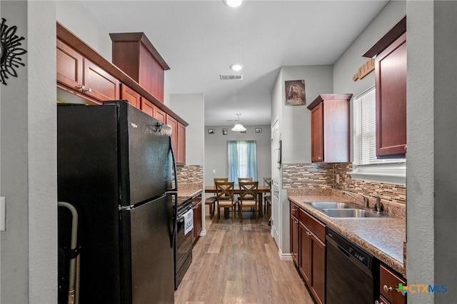 2709 Odem St, Victoria, TX 77901 - kitchen with black appliances, backsplash, light wood finished floors, and recessed lighting