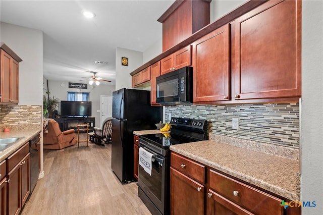 2709 Odem St, Victoria, TX 77901 - kitchen with black appliances, light wood-style floors, a ceiling fan, tasteful backsplash, and light countertops