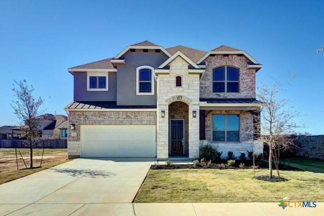 view of front of home featuring a garage and a front lawn