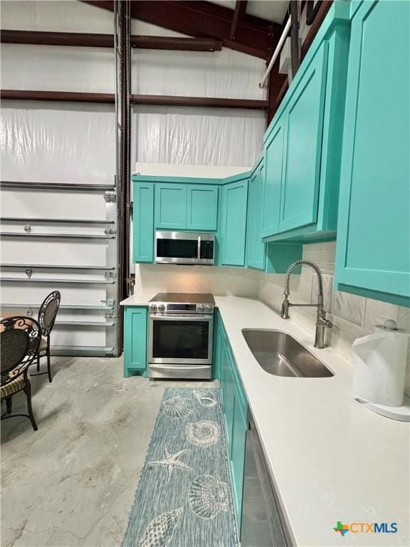 kitchen featuring concrete flooring, sink, and stainless steel appliances