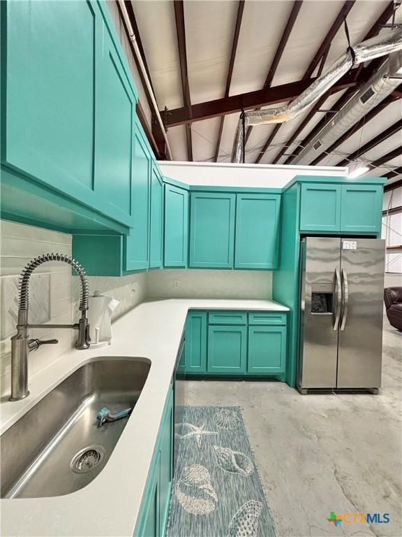 kitchen featuring stainless steel fridge and sink