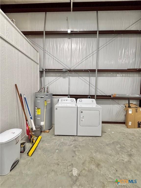 laundry room with washing machine and clothes dryer and water heater