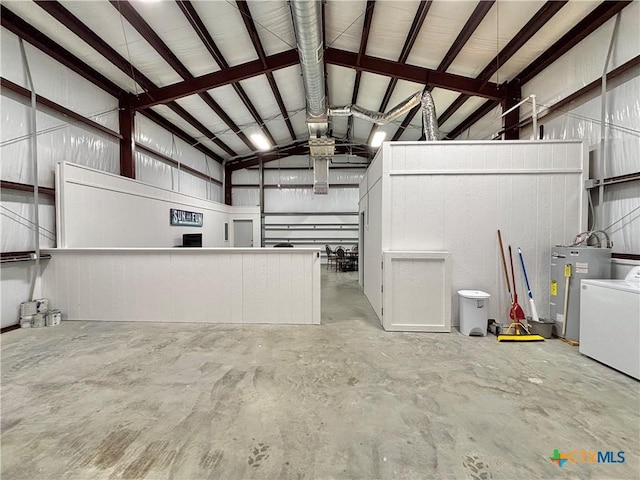 garage featuring washer / dryer and electric water heater