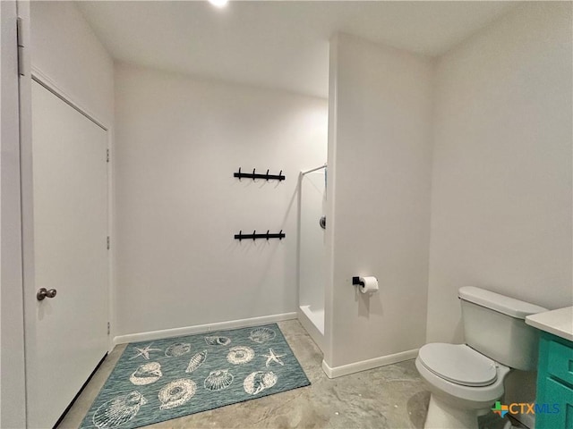 bathroom with vanity, toilet, and a shower