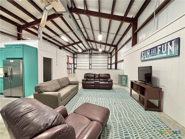 living room featuring beam ceiling and high vaulted ceiling