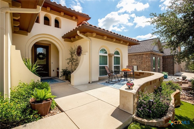 property entrance with a patio