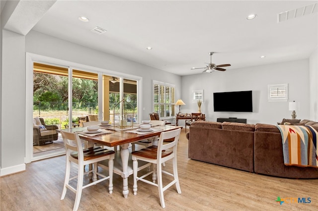 dining space featuring light wood-type flooring, a healthy amount of sunlight, and ceiling fan