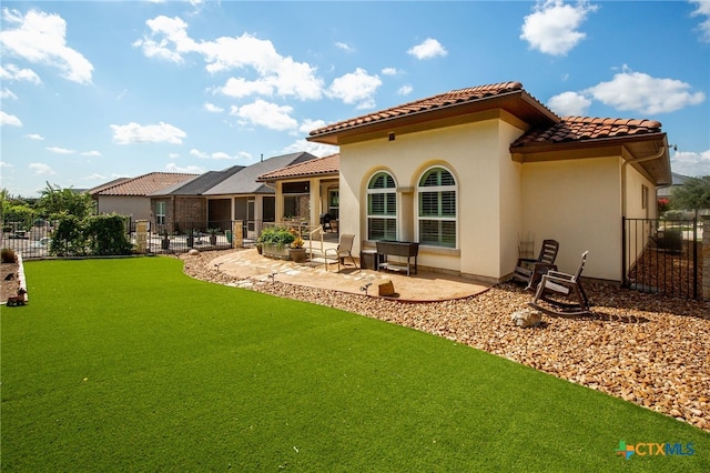 back of property featuring a patio and a lawn