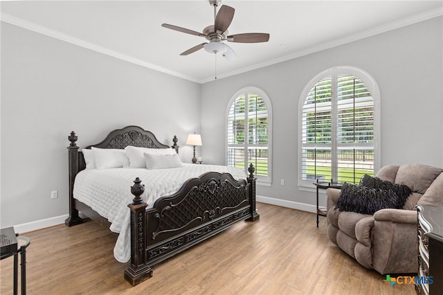 bedroom with ceiling fan, light wood-type flooring, and ornamental molding